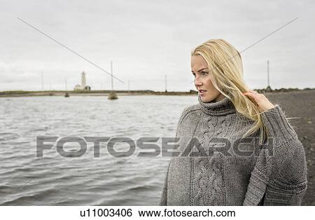 Mid adult woman gazing out to sea, Grotta, Seltjarnarnes, Iceland View Large Photo Image Stock Photograph - Mid adult woman gazing out to sea, Grotta, Seltjarnarnes, Iceland. Fotosearch
