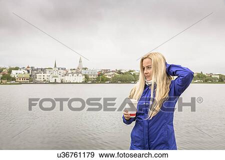 Mid adult woman with takeaway coffee, Laugarvatn, Iceland View Large Photo Image Stock Photo - Mid adult woman with takeaway coffee, Laugarvatn, Iceland. Fotosearch