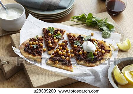 Middle eastern lamb and chickpea pizza with herb garnish and lemon slices View Large Photo Image Stock Image - Middle eastern lamb and chickpea pizza with herb garnish and lemon slices. Fotosearch