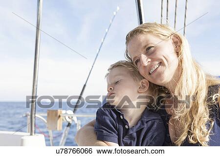 Stock Photograph - Mother and young son on catamaran near Fuerteventura, Spain. Fotosearch