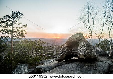 Mountain rock formation and fallen tree at sunset View Large Photo Image Stock Image - Mountain rock formation and fallen tree at sunset. Fotosearch