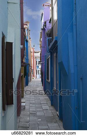 Stock Image - Multi colored houses in narrow alley, Burano, Venice, Veneto, Italy. Fotosearch