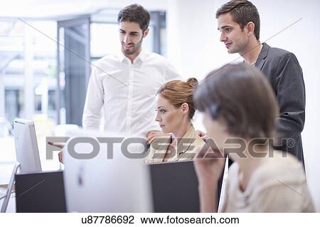 Office colleagues looking at computer View Large Photo Image Stock Image - Office colleagues looking at computer. Fotosearch