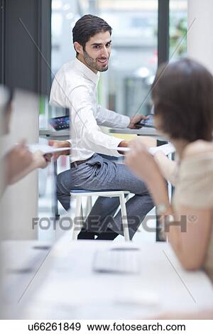 Office worker looking over shoulder towards colleague View Large Photo Image Stock Photo - Office worker looking over shoulder towards colleague. Fotosearch