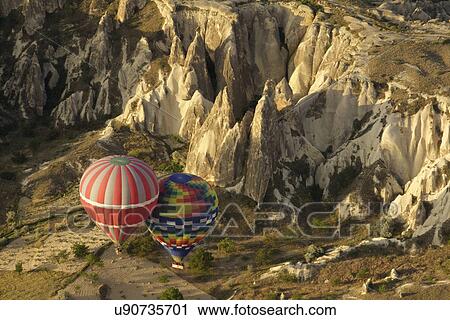 Pair of hot air balloons floating next to each other in valley, Cappadocia, Anatolia, Turkey View Large Photo Image Stock Image - Pair of hot air balloons floating next to each other in valley, Cappadocia, Anatolia, Turkey. Fotosearch