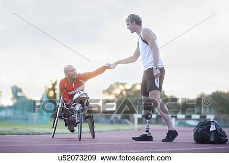 Stock Photo - Para-athletes doing fist bump. Fotosearch