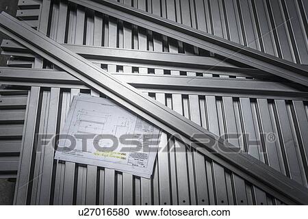 Stock Image - Parts with engineering drawings in sheet metal factory. Fotosearch