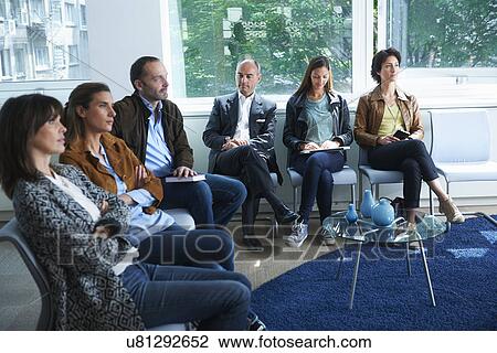 Stock Image - People sitting in waiting room. Fotosearch