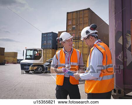 Port workers and shipping containers in port View Large Photo Image Stock Image - Port workers and shipping containers in port. Fotosearch