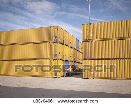 Port workers and shipping containers in port View Large Photo Image Stock Image - Port workers and shipping containers in port. Fotosearch