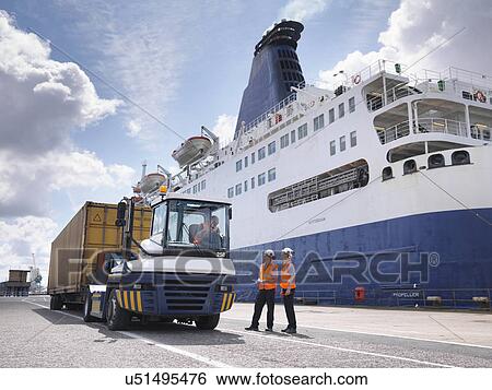 Port workers on dock side beside ship View Large Photo Image Stock Photograph - Port workers on dock side beside ship. Fotosearch
