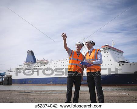 Port workers with ship in port View Large Photo Image Stock Image - Port workers with ship in port. Fotosearch