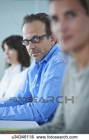 Stock Photo - Portrait of businessman in row of colleagues. Fotosearch
