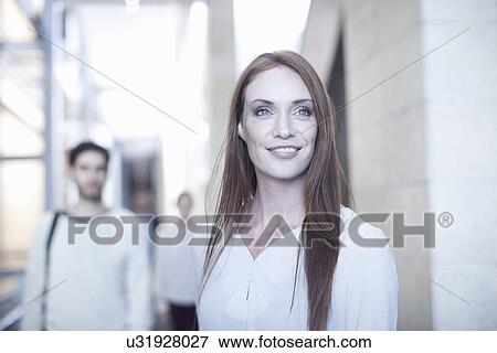 Stock Photo - Portrait of mid adult businesswoman in conference centre. Fotosearch