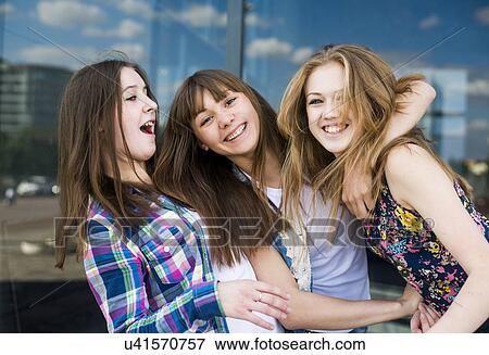 Stock Photo - Portrait of three young women in a row. Fotosearch