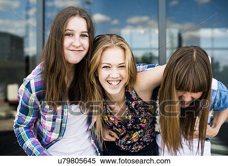 Portrait of three young women laughing in front of glass office building View Large Photo Image Stock Photography - Portrait of three young women laughing in front of glass office building. Fotosearch