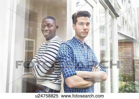 Portrait of two young men back to back in garden View Large Photo Image Stock Photography - Portrait of two young men back to back in garden. Fotosearch