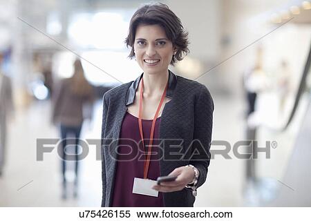 Stock Photography - Portrait of young businesswoman in conference centre. Fotosearch