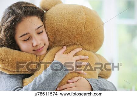 Portrait of young girl hugging teddy bear View Large Photo Image Picture - Portrait of young girl hugging teddy bear. Fotosearch