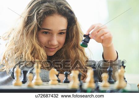 Portrait of young girl playing chess View Large Photo Image Stock Image - Portrait of young girl playing chess. Fotosearch