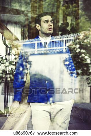 Portrait of young man in vintage clothes gazing through window View Large Photo Image Stock Photo - Portrait of young man in vintage clothes gazing through window. Fotosearch