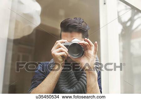 Portrait of young man photographing with SLR camera View Large Photo Image Picture - Portrait of young man photographing with SLR camera. Fotosearch