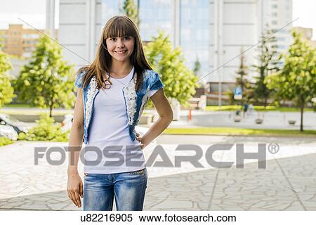 Portrait of young woman posing with hand on hip in city View Large Photo Image Stock Photography - Portrait of young woman posing with hand on hip in city. Fotosearch
