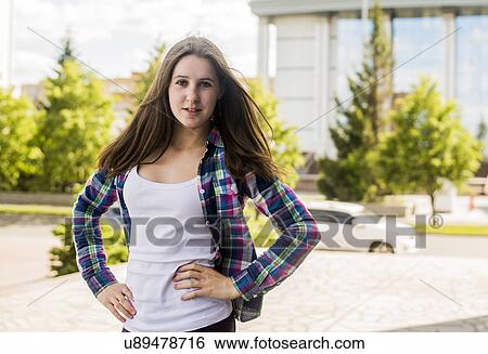 Portrait of young woman with hands on hips in city View Large Photo Image Stock Photograph - Portrait of young woman with hands on hips in city. Fotosearch