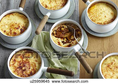 Potato lamb moussaka in individual saucepans View Large Photo Image Stock Photography - Potato lamb moussaka in individual saucepans. Fotosearch