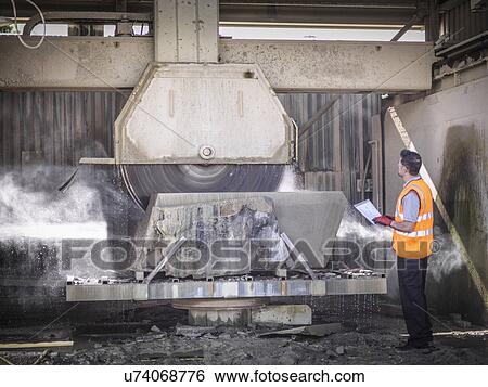 Quarry worker inspecting stone saw View Large Photo Image Stock Photograph - Quarry worker inspecting stone saw. Fotosearch