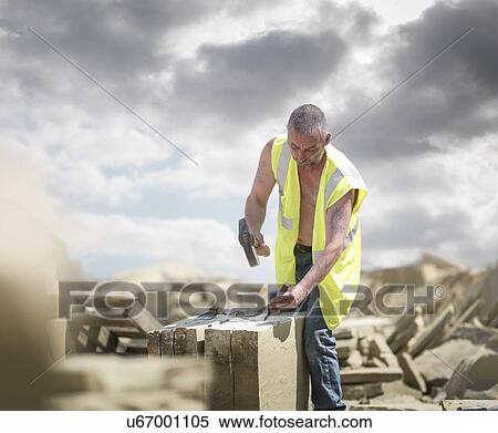 Stock Photography - Quarry worker shaping sandstone in Yorkshire stone quarry. Fotosearch