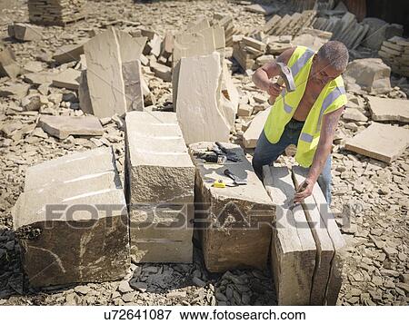 Quarry worker splitting sandstone in Yorkshire stone quarry, elevated view View Large Photo Image Stock Photo - Quarry worker splitting sandstone in Yorkshire stone quarry, elevated view. Fotosearch
