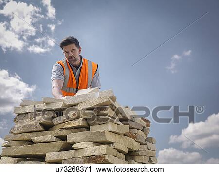 Quarry worker stacking sandstone in Yorkshire stone quarry View Large Photo Image Stock Image - Quarry worker stacking sandstone in Yorkshire stone quarry. Fotosearch