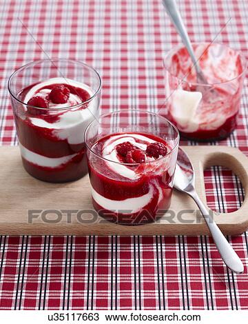 Stock Image - Raspberry swirl desserts garnished with fresh raspberries. Fotosearch