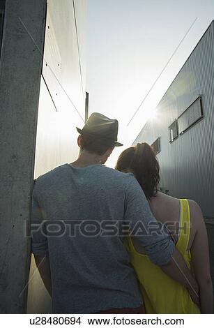Picture - Rear view of young couple in street. Fotosearch