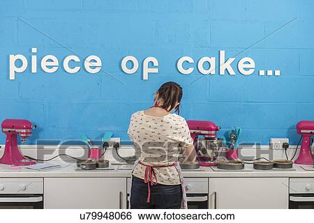 Rear view of young woman using blender in bakery View Large Photo Image Stock Photograph - Rear view of young woman using blender in bakery. Fotosearch