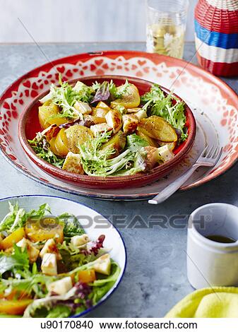 Stock Image - Roast golden beetroot and halloumi. Fotosearch