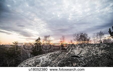 Rock formation and tree tops at sunset View Large Photo Image Stock Image - Rock formation and tree tops at sunset. Fotosearch