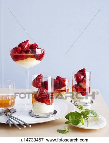 Selection of drinking glasses filled with champagne poached strawberry desserts View Large Photo Image Stock Photo - Selection of drinking glasses filled with champagne poached strawberry desserts. Fotosearch
