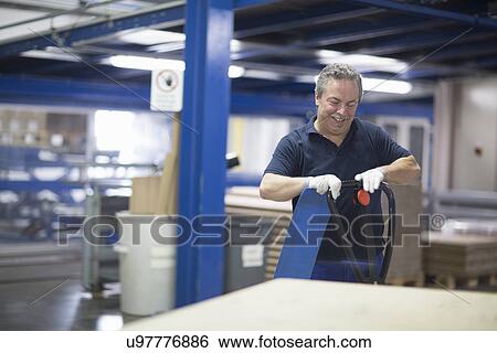 Senior factory worker using hand pallet truck View Large Photo Image Stock Photograph - Senior factory worker using hand pallet truck. Fotosearch