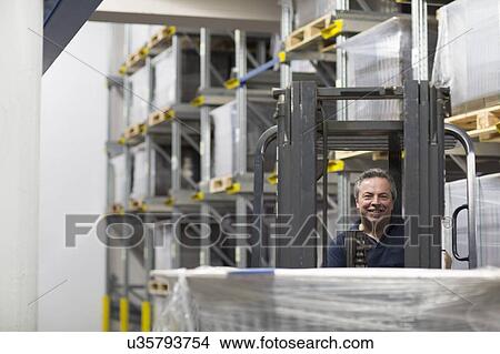 Senior man using forklift truck in factory View Large Photo Image Picture - Senior man using forklift truck in factory. Fotosearch
