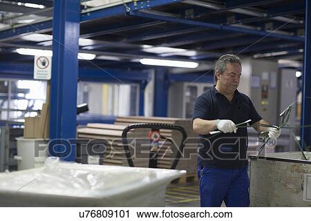 Stock Image - Senior man working in factory. Fotosearch