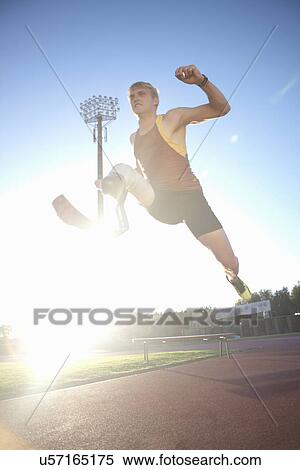 Stock Photography - Sprinter mid-jump. Fotosearch