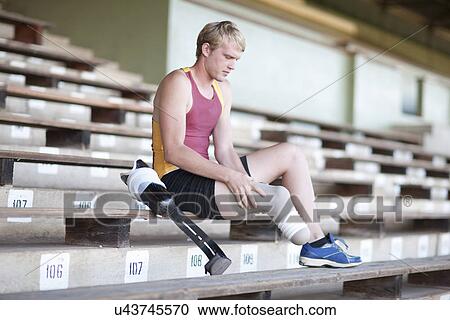 Sprinter preparing, putting on prosthetic leg View Large Photo Image Stock Image - Sprinter preparing, putting on prosthetic leg. Fotosearch
