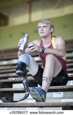 Sprinter sitting with prosthetic leg on View Large Photo Image Stock Photo - Sprinter sitting with prosthetic leg on. Fotosearch