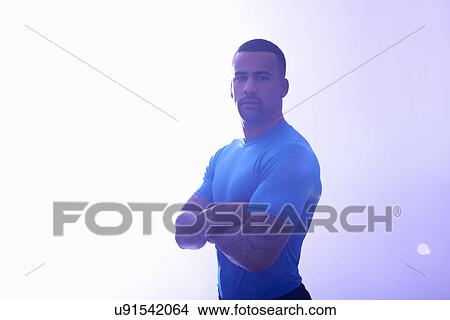 Studio portrait of muscular sportsman with arms folded View Large Photo Image Picture - Studio portrait of muscular sportsman with arms folded. Fotosearch