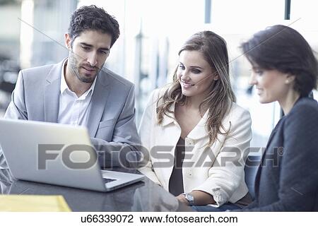 Three business colleagues with laptop in conference centre View Large Photo Image Stock Image - Three business colleagues with laptop in conference centre. Fotosearch