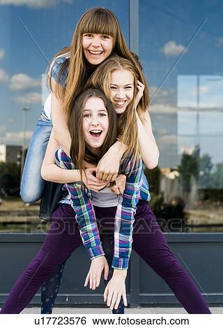 Three young women stacked on top of each other in city View Large Photo Image Stock Photograph - Three young women stacked on top of each other in city. Fotosearch