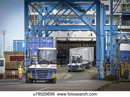Truck loading containers onto ship in port View Large Photo Image Stock Photo - Truck loading containers onto ship in port. Fotosearch
