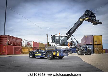Stock Photo - Truck stacking shipping containers in port. Fotosearch